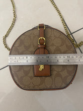 Signature Round Sling Bag