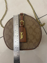 Signature Round Sling Bag