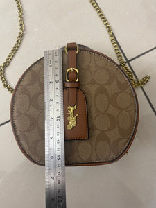 Signature Round Sling Bag
