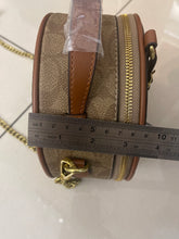 Signature Round Sling Bag